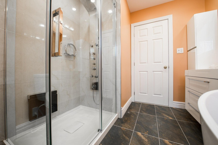 Bathroom remodel with custom tile shower and glass enclosure
