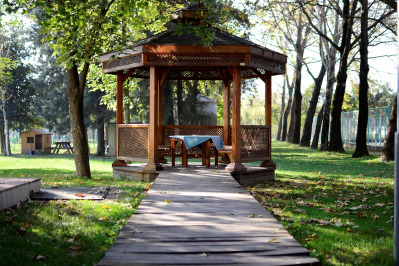 Wood pergola providing shade over a backyard patio